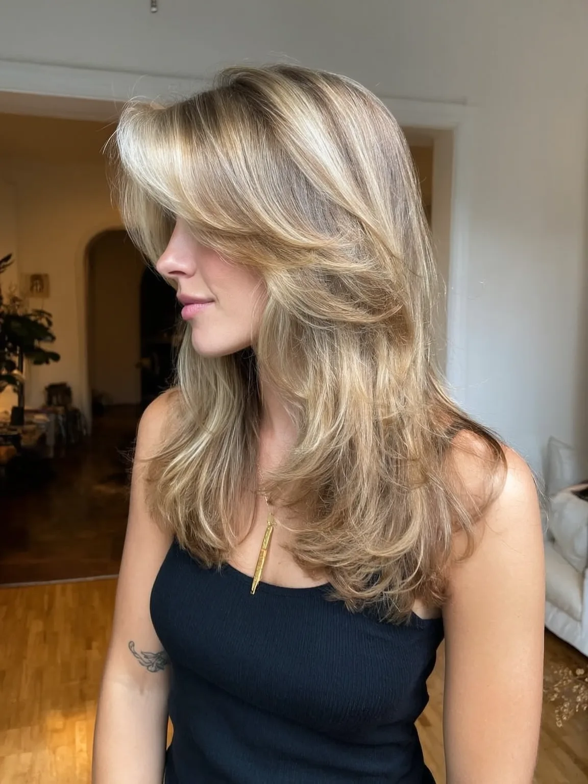 Long Honey Blonde Balayage Layers with Side-Swept Bangs